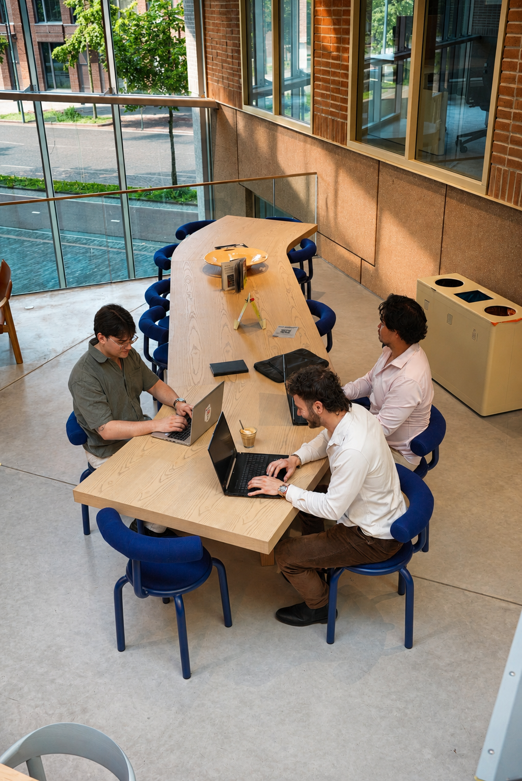 Overhead shot van een coworking sessie met laptops